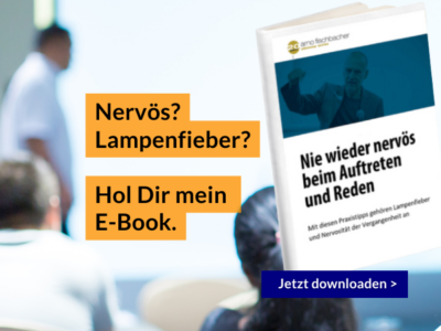 Werbebild für ein E-Book zum Überwinden von Nervosität bei Vorträgen. Der Text lautet: „Nervös? Lampenfieber? Hol Dir mein E-Book. Nie wieder nervös beim Auftreten und Reden. Jetzt herunterladen >“.