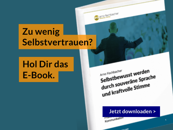 E-Book-Cover mit einer erhobenen Hand im Hintergrund. Der deutsche Text auf den gelben Kästen lautet: „Zu wenig Selbstvertrauen? Hol Dir das E-Book.“ Der blaue Buttontext lautet „Jetzt herunterladen >“.