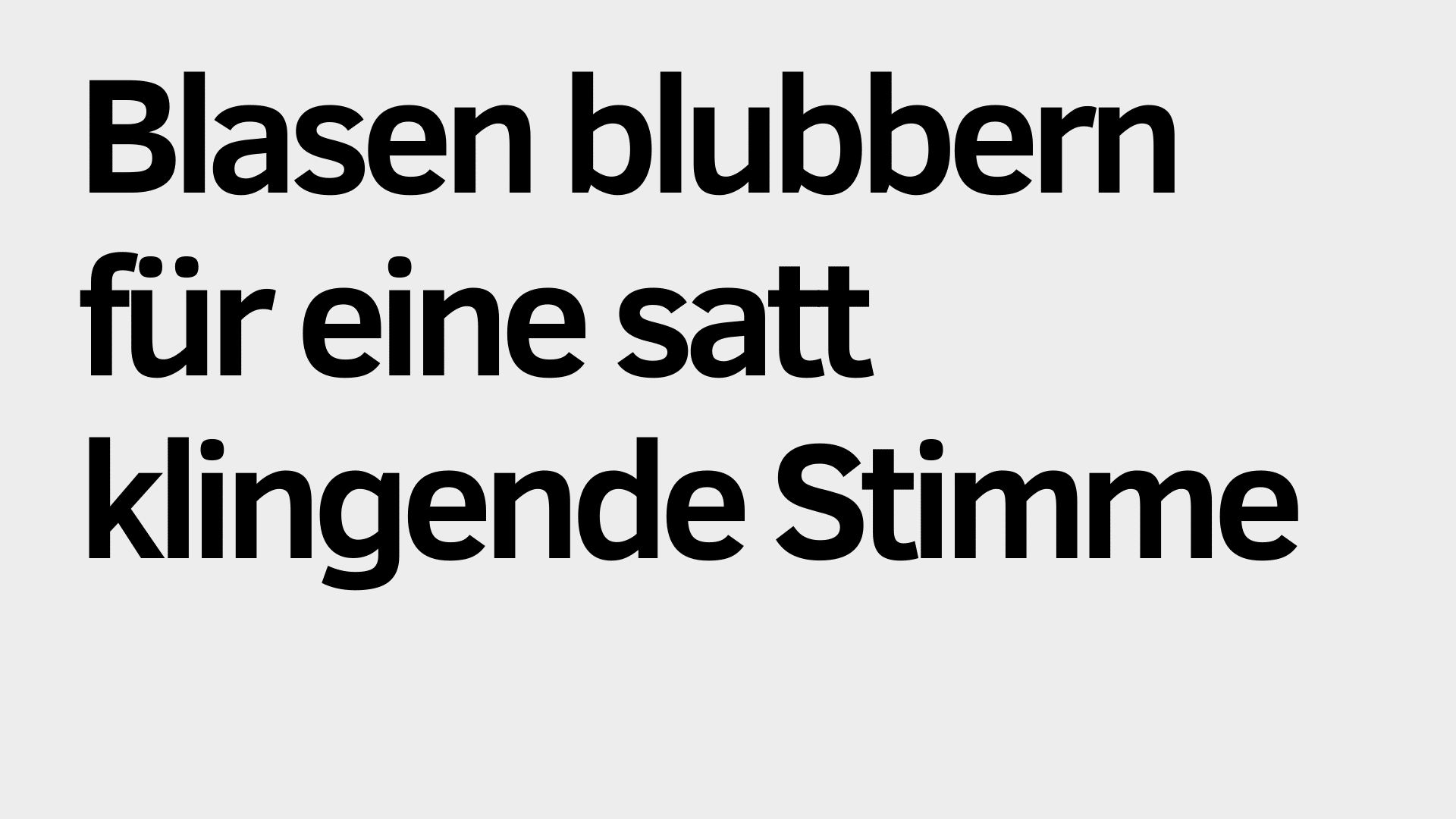 Der fette schwarze deutsche Text auf hellgrauem Hintergrund lautet: "Blasen blubbern für eine satt klingende Stimme - perfekt zur Stimmaufwärmung.